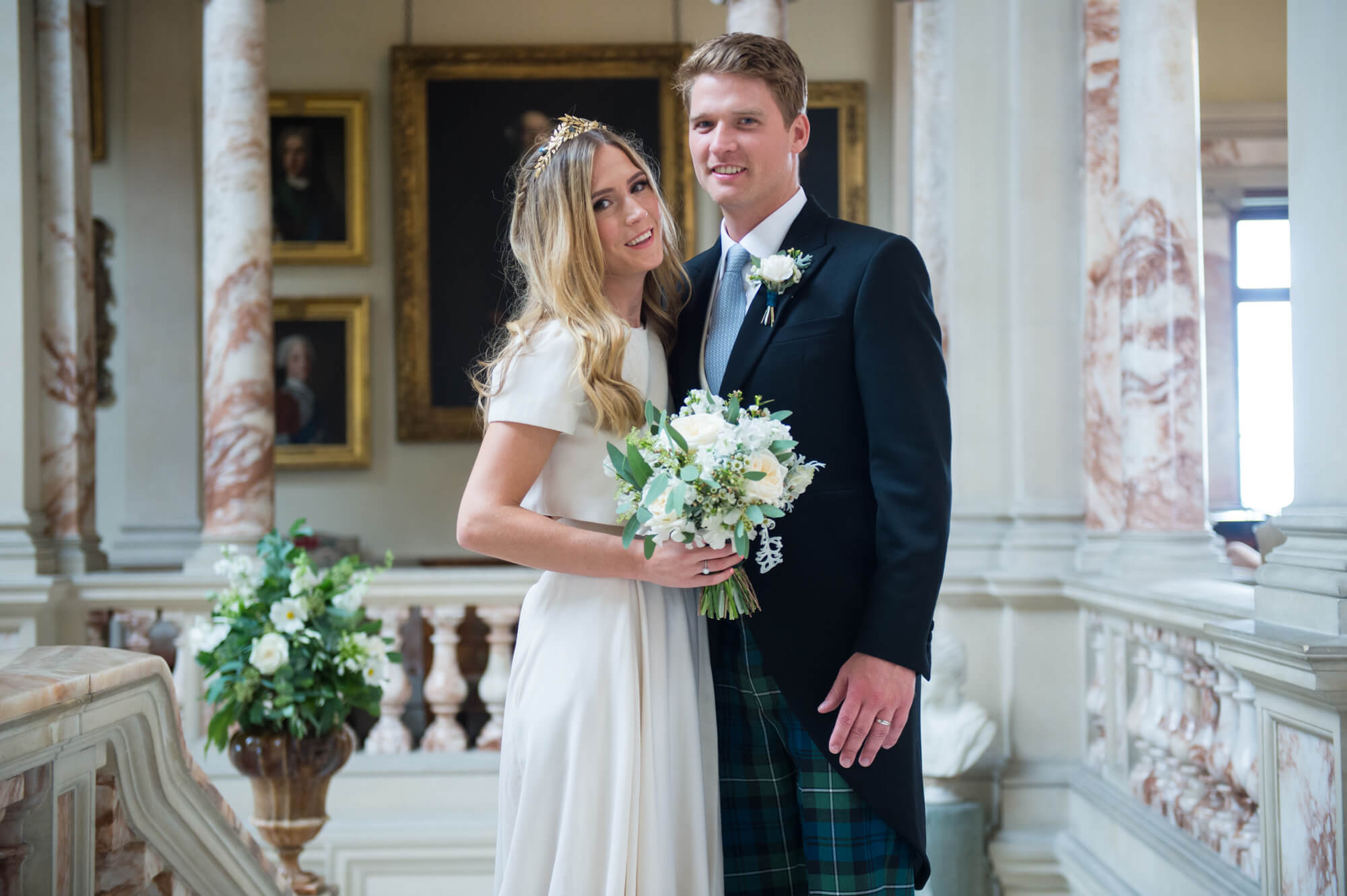bride and groom in the great marble hall at gosford house during their wedding reception by especially amy wedding photography